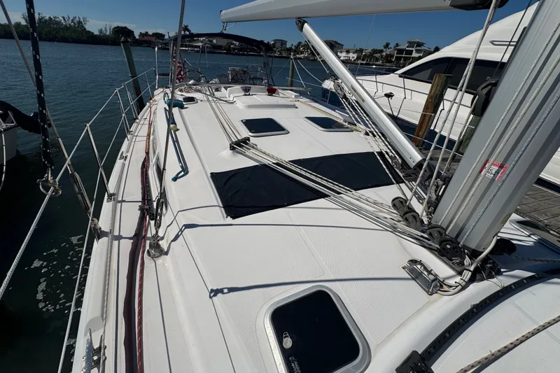 Slide: The Image of Sailboat deck of 2009 Hunter 49 model, docked at marina under clear blue sky. - 96