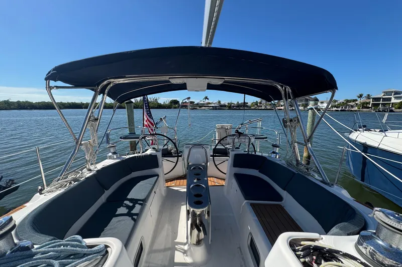 Slide: The Image of 2009 Hunter 49 sailboat cockpit with canopy, docked on a sunny day. - 74