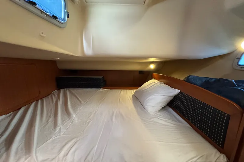 Slide: The Image of Cozy cabin interior of 2009 Hunter 49 yacht with bed and porthole window. - 45
