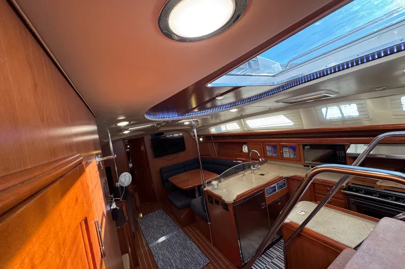 Slide: The Image of Luxurious interior of 2009 Hunter 49 yacht with skylight, kitchen, and seating area. - 14