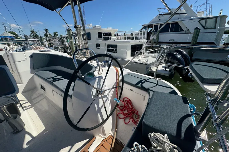 Slide: The Image of Cockpit of 2009 Hunter 49 sailboat with steering wheel, docked at marina. - 83