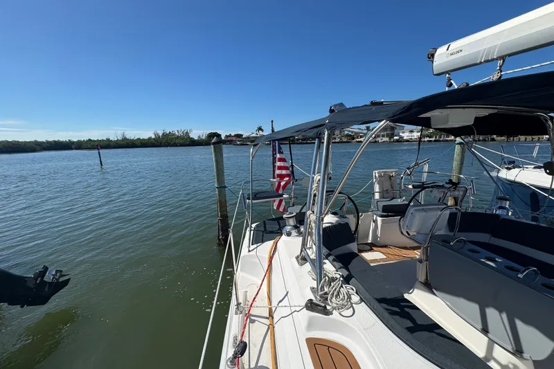 Slide: The Image of Sailboat docked by the water, Hunter 49 model, 2009, with American flag. - 104
