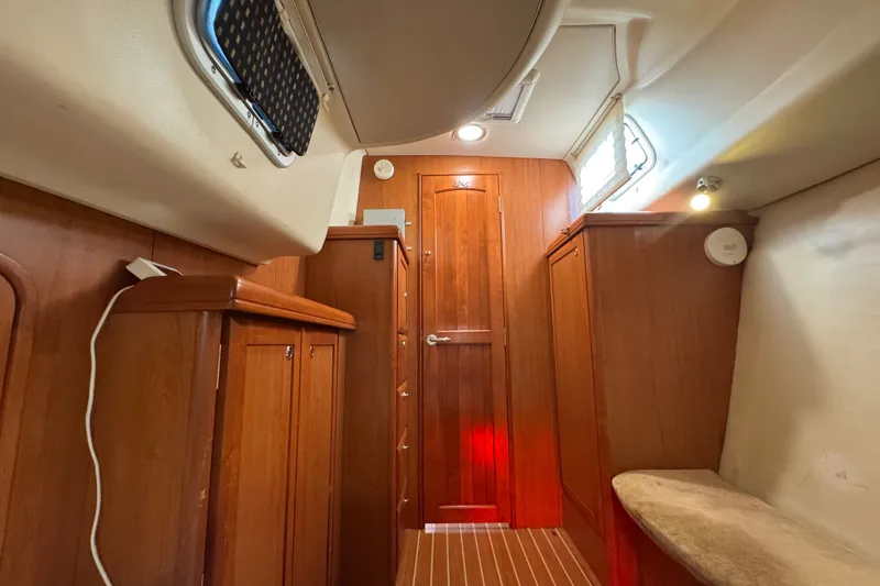 Slide: The Image of Interior of 2009 Hunter 49 sailboat with wooden cabinetry and cozy lighting. - 20