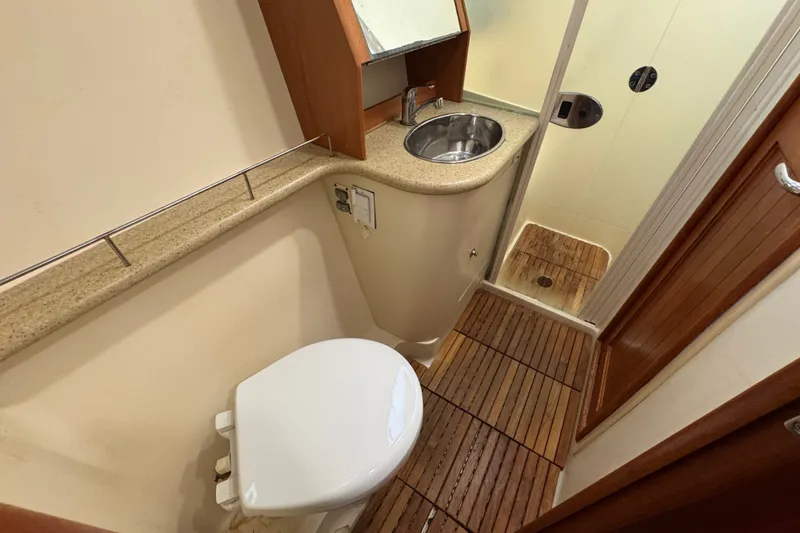 Slide: The Image of Compact bathroom in a 2009 Hunter 49 yacht with toilet, sink, and shower. - 49