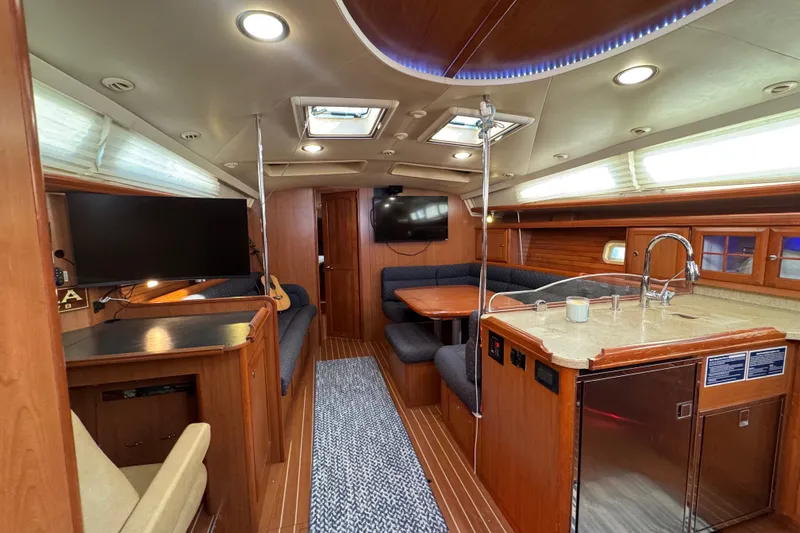 Slide: The Image of Luxurious interior of a 2009 Hunter 49 yacht with modern amenities and wood finishes. - 62