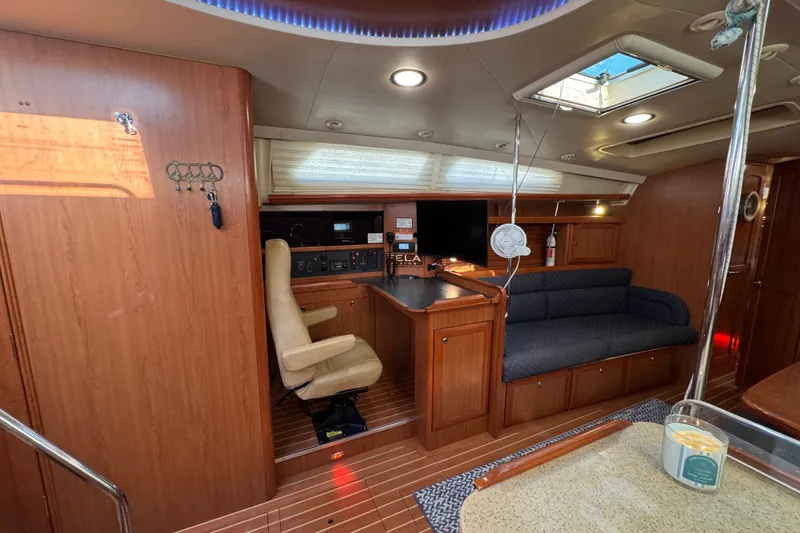 Slide: The Image of Interior of a 2009 Hunter 49 yacht featuring a navigation station and seating area. - 23