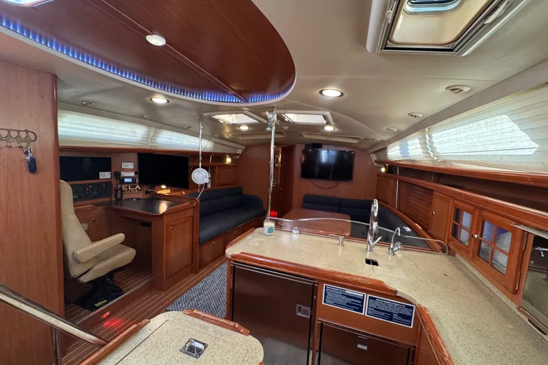 Slide: The Image of Luxurious interior of a 2009 Hunter 49 yacht with modern amenities and elegant wood finishes. - 22