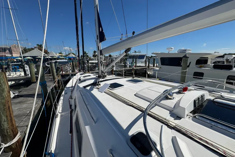 Slide: The Image of 2009 Hunter 49 sailboat docked at marina under clear blue sky. - 91
