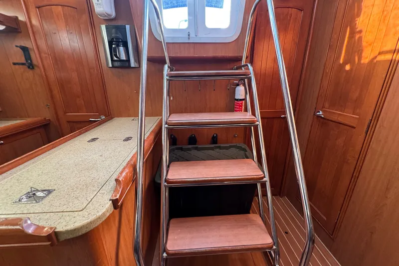 Slide: The Image of Interior of 2009 Hunter 49 yacht with wooden cabinetry and metal ladder. - 68