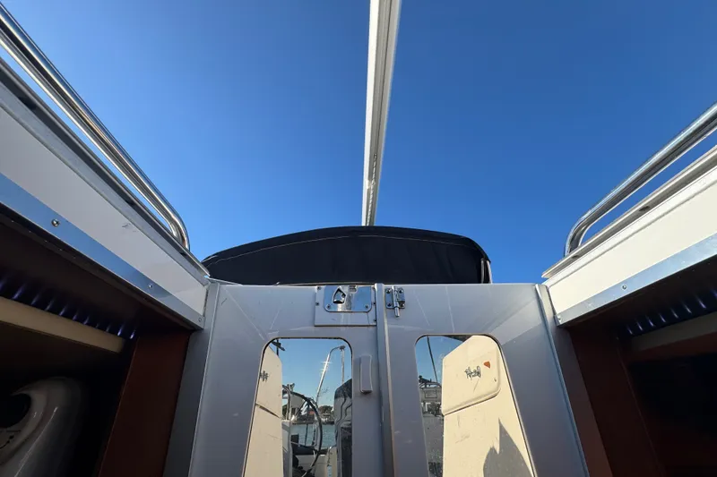 Slide: The Image of 2009 Hunter 49 sailboat cockpit view under clear blue sky. - 71