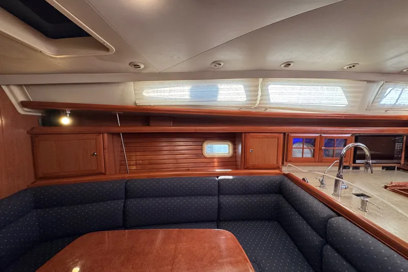 Slide: The Image of Interior of 2009 Hunter 49 yacht with cozy seating and wooden cabinetry. - 28