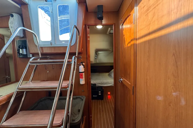 Slide: The Image of Interior of 2009 Hunter 49 yacht with wooden paneling and compact cabin space. - 43