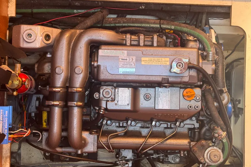 Slide: The Image of Engine compartment of a 2009 Hunter 49 sailboat, showcasing detailed mechanical components. - 117