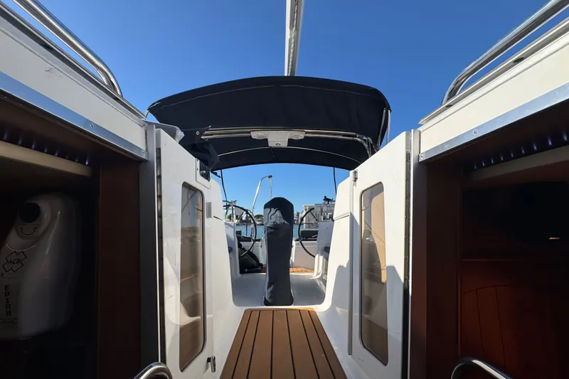 Slide: The Image of Interior view of a 2009 Hunter 49 sailboat cockpit with wooden flooring. - 72