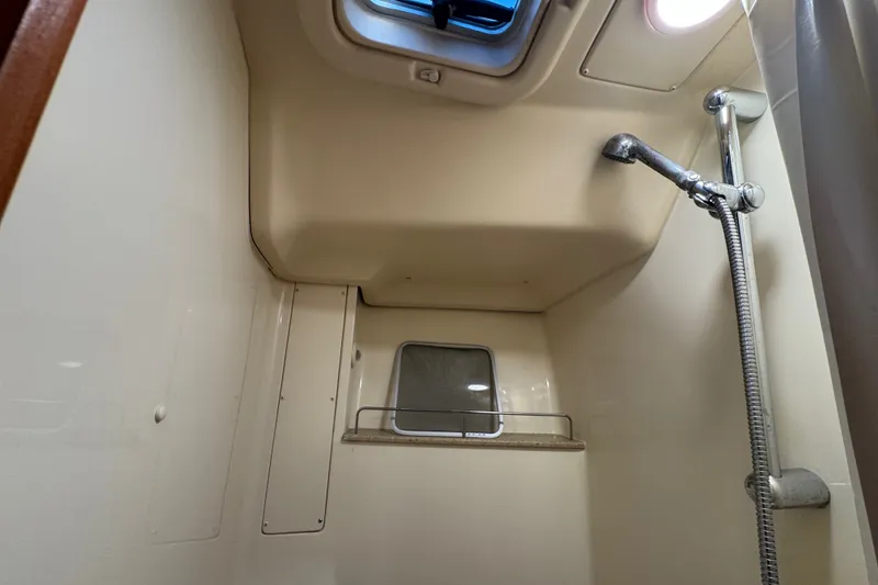 Slide: The Image of Interior shower of a 2009 Hunter 49 yacht, featuring a skylight and handheld showerhead. - 31