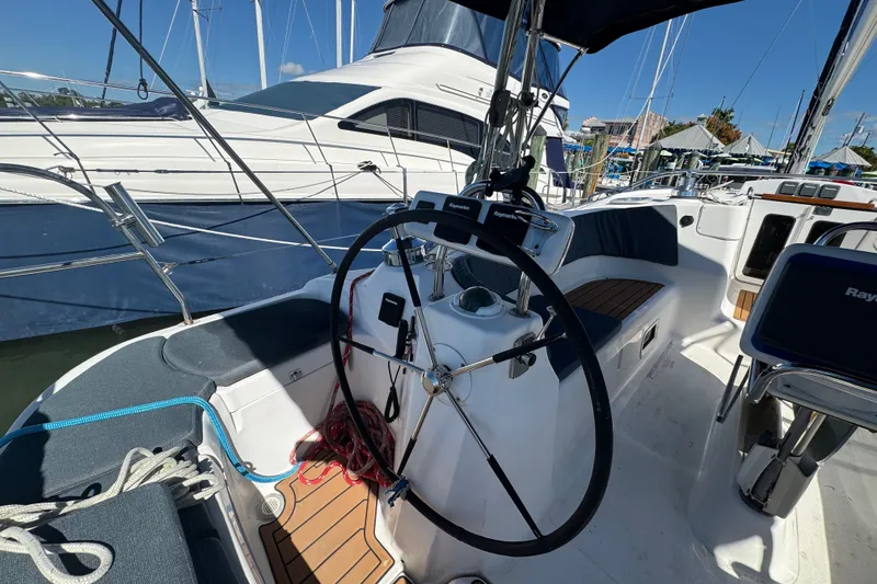 Slide: The Image of Cockpit of a 2009 Hunter 49 sailboat with steering wheel and navigation equipment. - 82