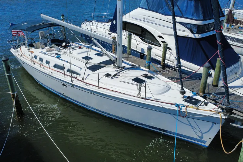 The Image of Sailboat docked at marina, 2009 Hunter 49 model, featuring sleek design and spacious deck. - 0