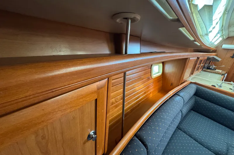 Slide: The Image of Interior of 2009 Hunter 49 yacht with wooden cabinetry and blue upholstered seating. - 66