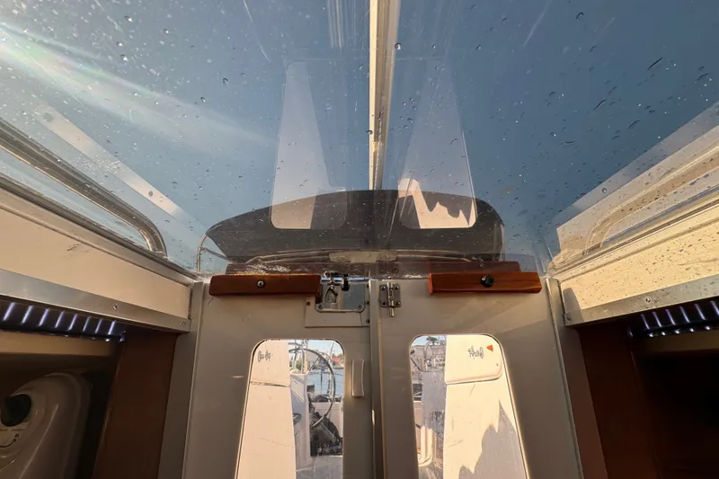 Slide: The Image of Interior view of a 2009 Hunter 49 sailboat cockpit with clear canopy. - 70