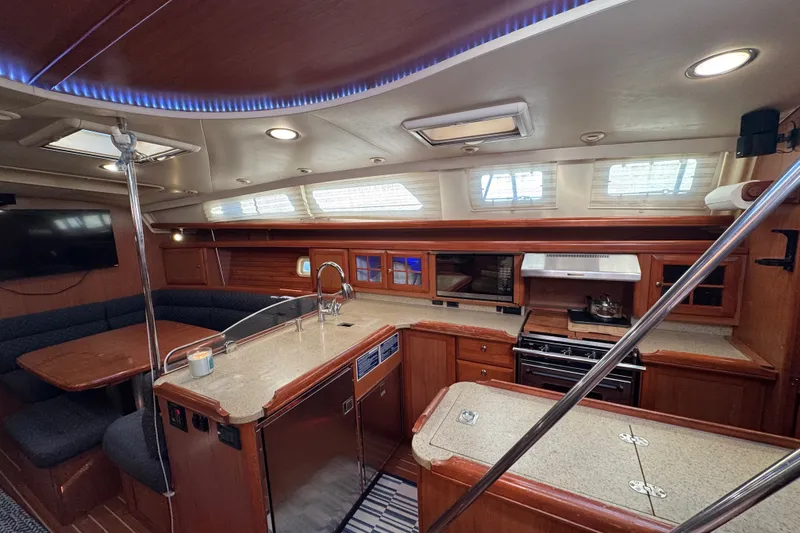 Slide: The Image of Luxurious 2009 Hunter 49 yacht interior with modern kitchen and cozy dining area. - 15