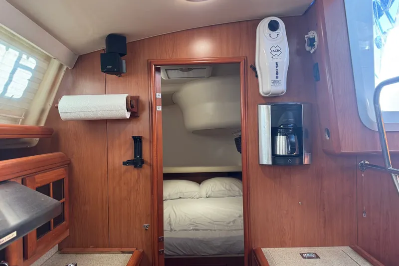 Slide: The Image of Interior of a 2009 Hunter 49 yacht featuring a cozy cabin and coffee maker. - 65