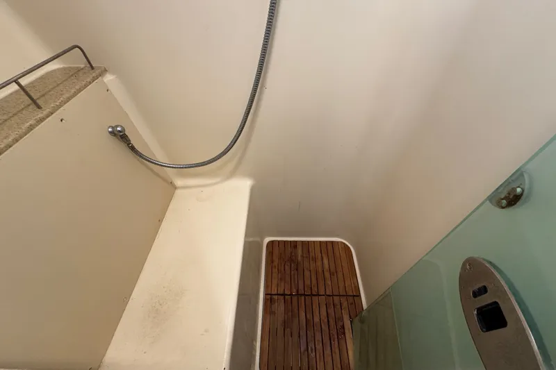 Slide: The Image of Shower area in a 2009 Hunter 49 yacht with wooden flooring and handheld showerhead. - 52