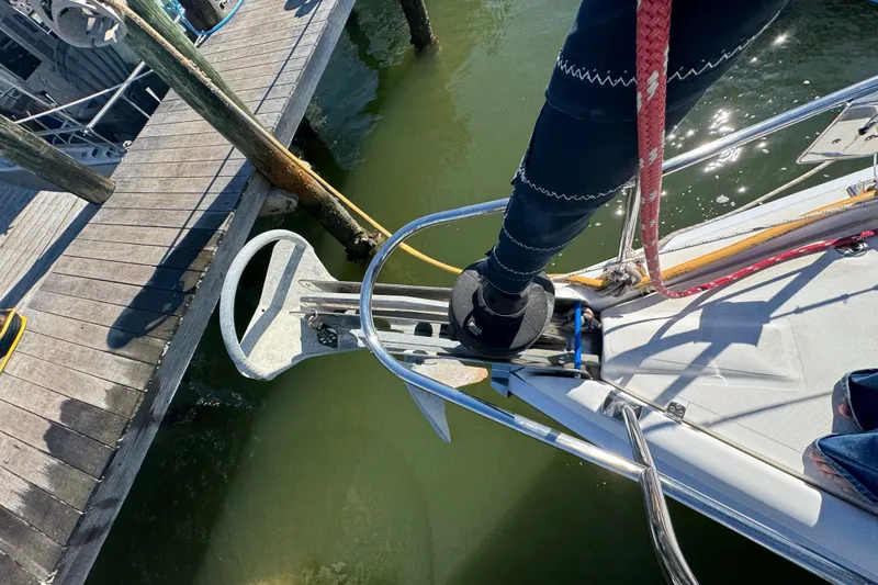 Slide: The Image of Bow of 2009 Hunter 49 sailboat docked, showing anchor and deck details. - 94