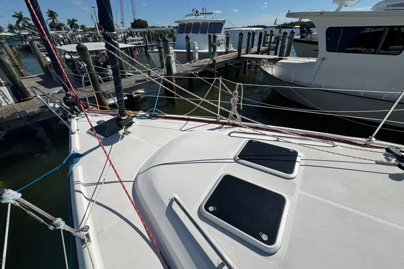 Slide: The Image of Sailboat deck view at marina, featuring a 2009 Hunter 49 model. - 93