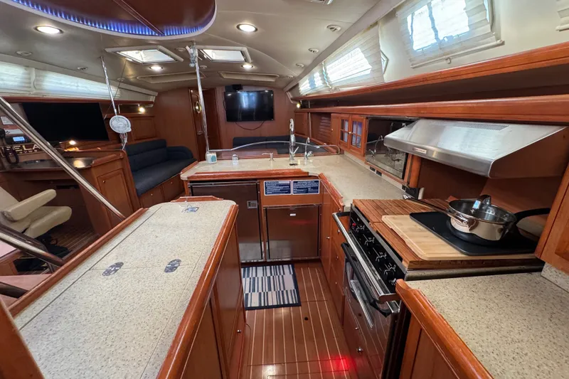 Slide: The Image of Luxurious interior of a 2009 Hunter 49 yacht featuring a modern kitchen and seating area. - 21