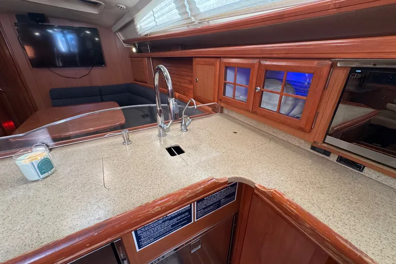 Slide: The Image of Luxurious 2009 Hunter 49 yacht interior with modern kitchen and cozy seating area. - 63