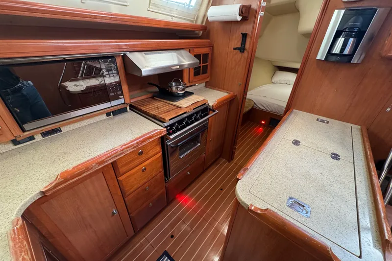 Slide: The Image of Luxurious 2009 Hunter 49 yacht interior with modern kitchen and cozy sleeping area. - 17