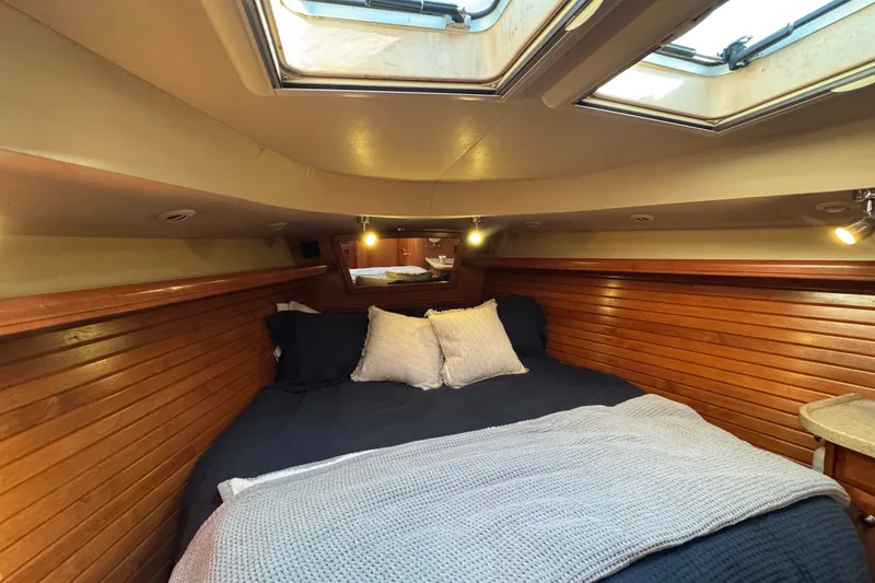 Slide: The Image of Cozy cabin interior of 2009 Hunter 49 yacht with skylights and wooden paneling. - 33