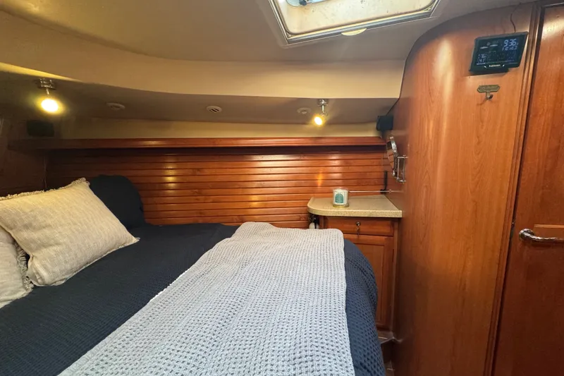 Slide: The Image of Cozy cabin interior of 2009 Hunter 49 yacht with wooden paneling and comfortable bedding. - 34