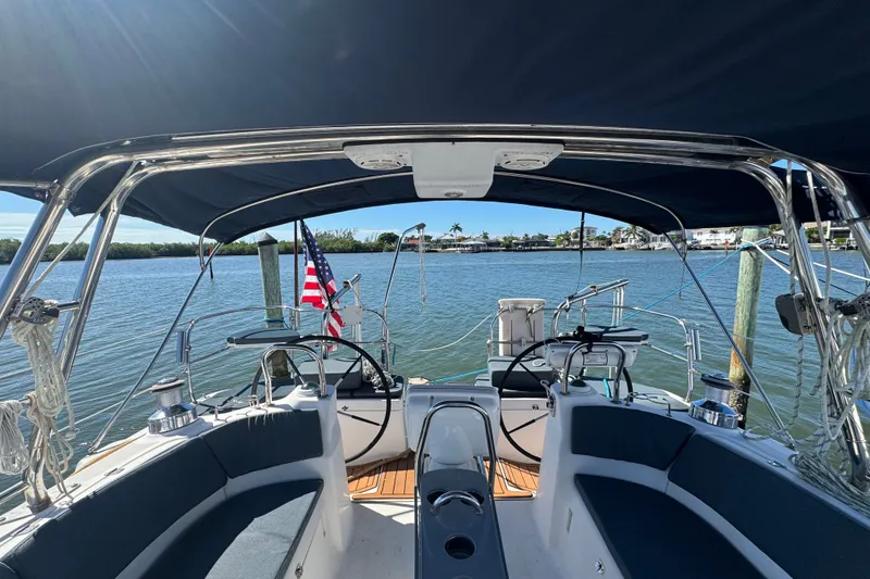 Slide: The Image of Cockpit view of 2009 Hunter 49 sailboat with American flag on calm water. - 75