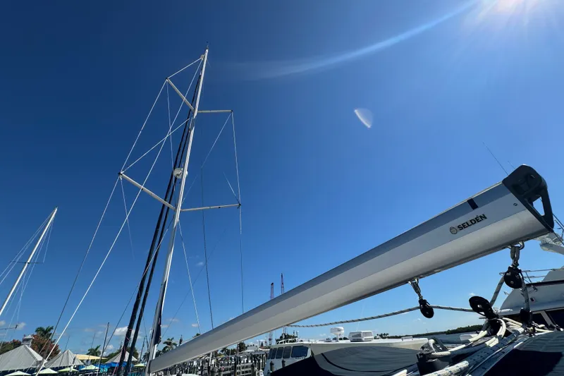Slide: The Image of Sailboat mast and boom of 2009 Hunter 49 under clear blue sky. - 90