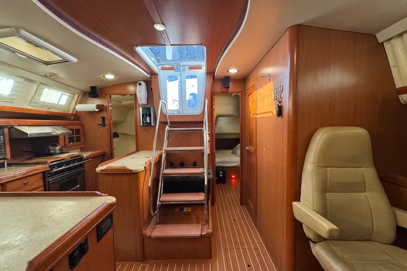 Slide: The Image of Interior of a 2009 Hunter 49 yacht featuring a cozy kitchen and seating area. - 42