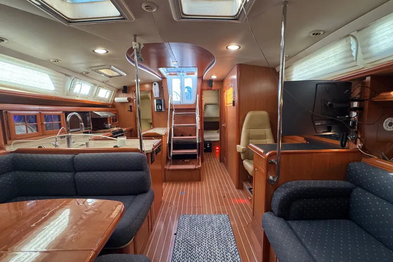 Slide: The Image of Luxurious interior of a 2009 Hunter 49 yacht with modern amenities and elegant wood finishes. - 41