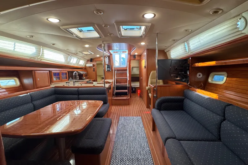 Slide: The Image of Luxurious interior of a 2009 Hunter 49 yacht with elegant wood finishes and comfortable seating. - 40