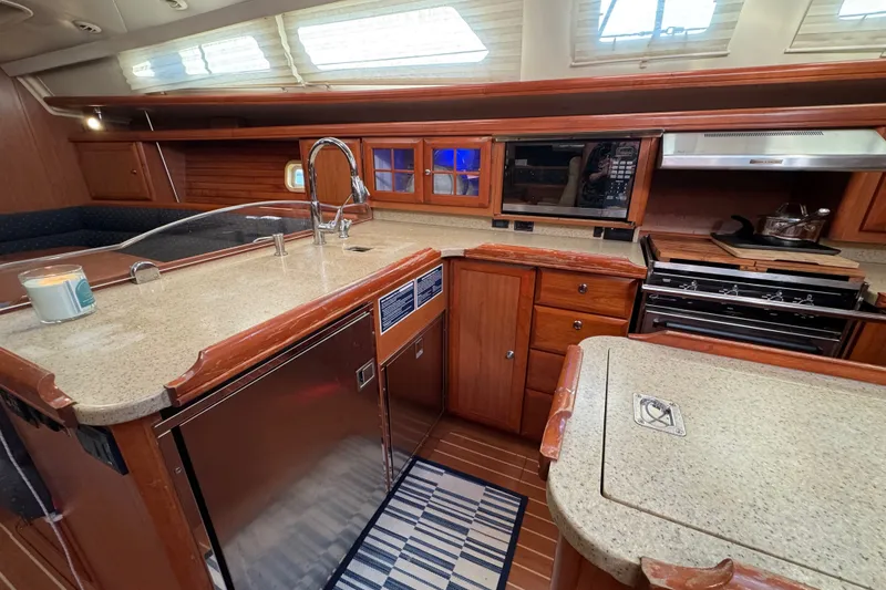 Slide: The Image of Luxurious 2009 Hunter 49 yacht kitchen with modern appliances and elegant wood cabinetry. - 16
