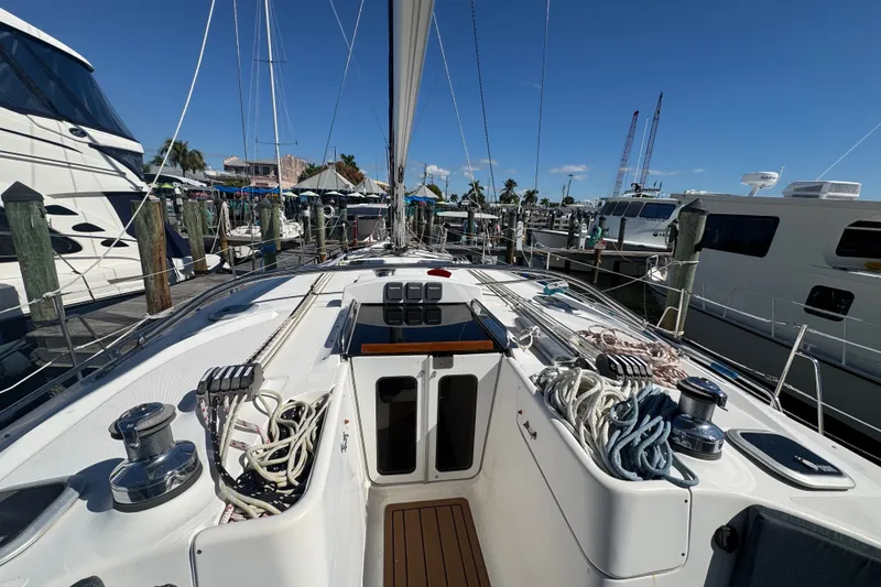 Slide: The Image of Sailboat deck view of 2009 Hunter 49, docked at marina with clear blue sky. - 86