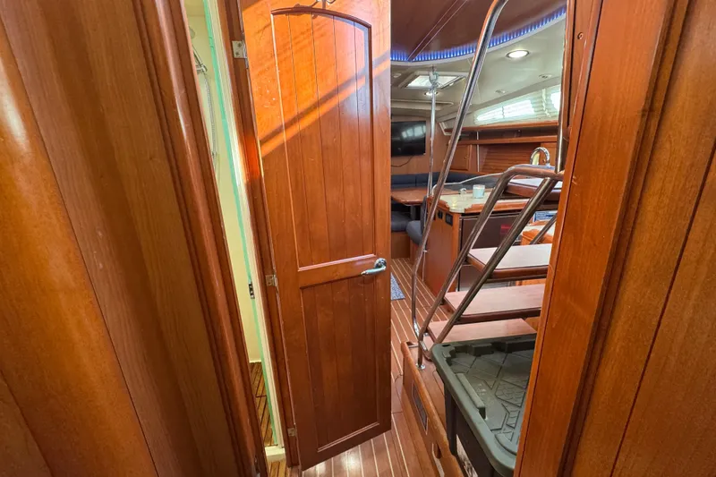 Slide: The Image of Interior of 2009 Hunter 49 yacht with wooden finishes and staircase. - 60
