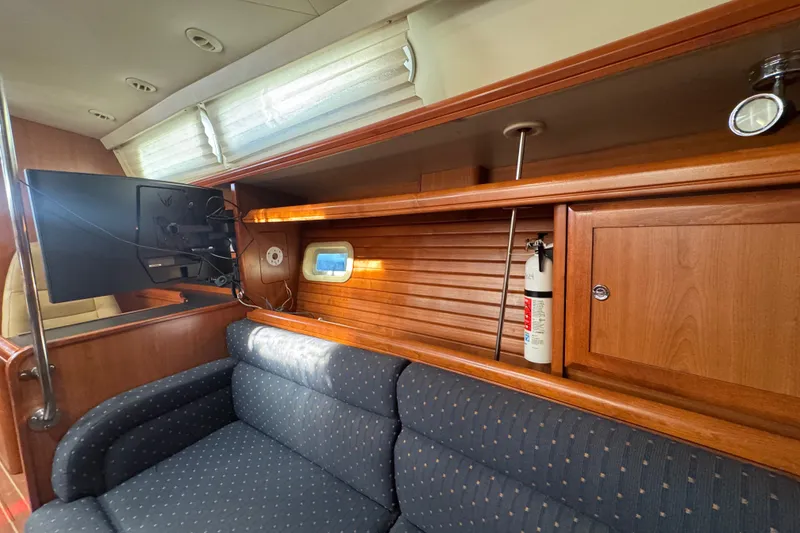 Slide: The Image of Interior of 2009 Hunter 49 yacht with TV, sofa, and wooden cabinetry. - 67
