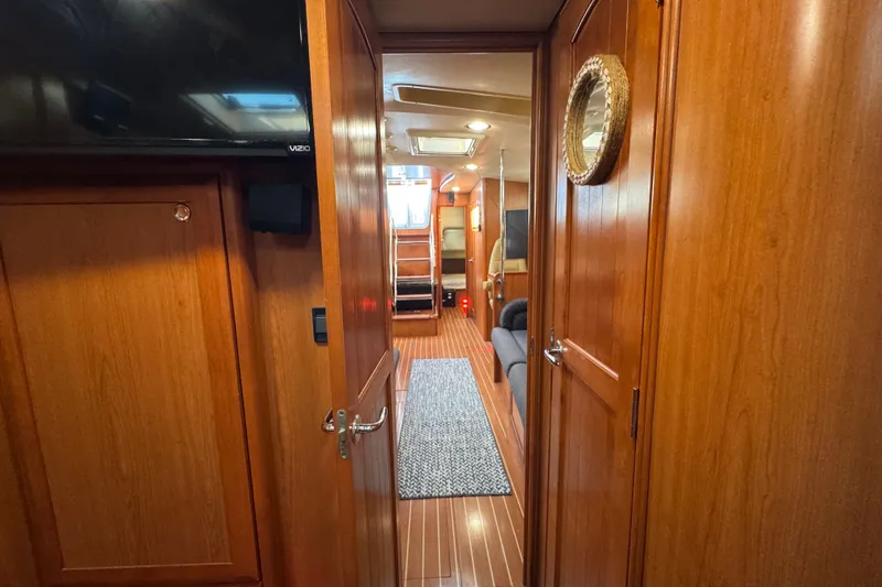 Slide: The Image of Interior view of a 2009 Hunter 49 yacht, featuring wooden paneling and cozy cabin layout. - 39