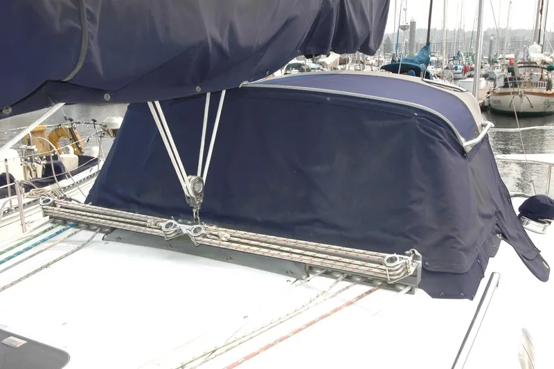 Slide: The Image of Sailboat deck of 2000 Catalina 380 with blue canvas cover in marina. - 19