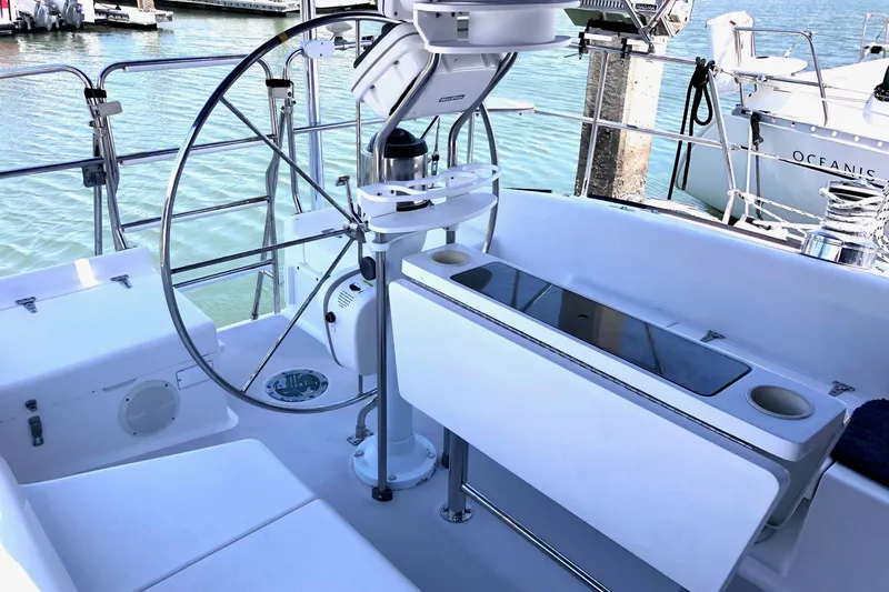 Slide: The Image of Cockpit of 2000 Catalina 380 sailboat with steering wheel and seating area. - 21
