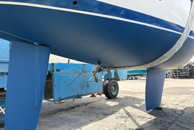 Slide: The Image of 2000 Catalina 380 sailboat hull and keel in dry dock, with visible propeller. - 28
