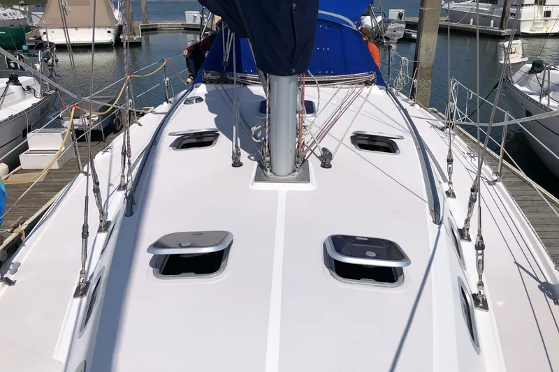 Slide: The Image of Deck view of a 2000 Catalina 380 sailboat docked at a marina. - 17