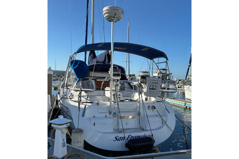 Slide: The Image of Catalina 380 sailboat, 2000 model, docked in a marina with blue canopy. - 24
