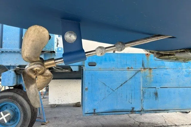 Slide: The Image of Propeller and shaft of a 2000 Catalina 380 sailboat, displayed on a blue background. - 29