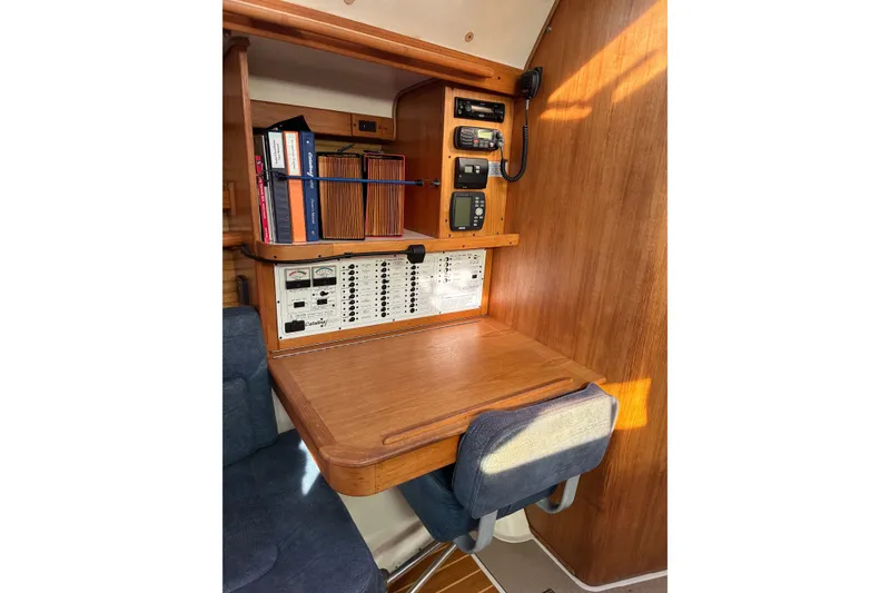 Slide: The Image of Navigation station in a 2000 Catalina 380 sailboat with control panel and equipment. - 6